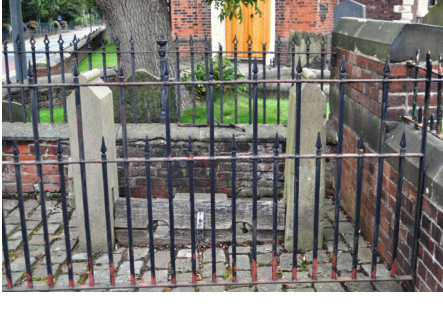 Village Stocks against St Lukes churchyard wall